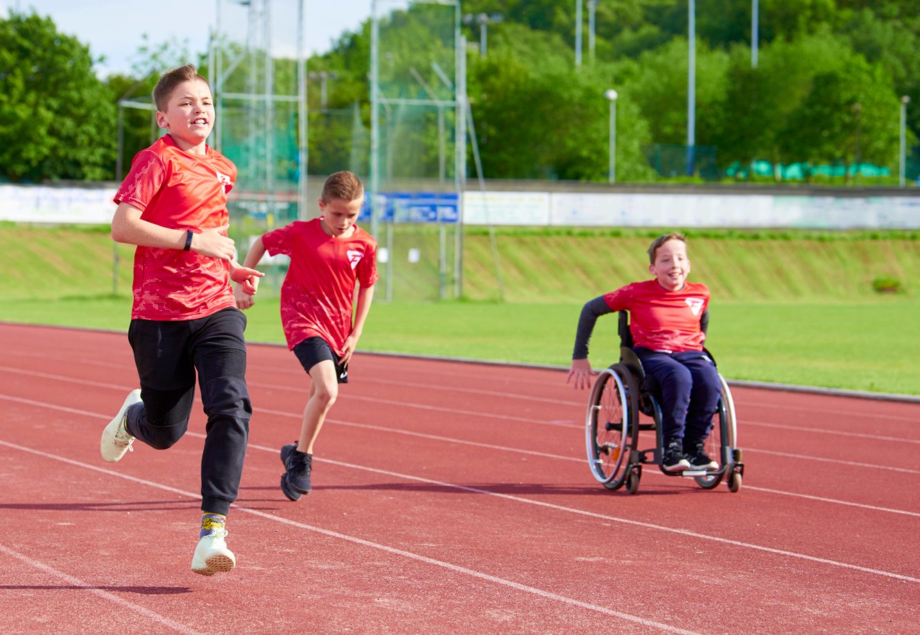 Children taking part in physical activity on a tr